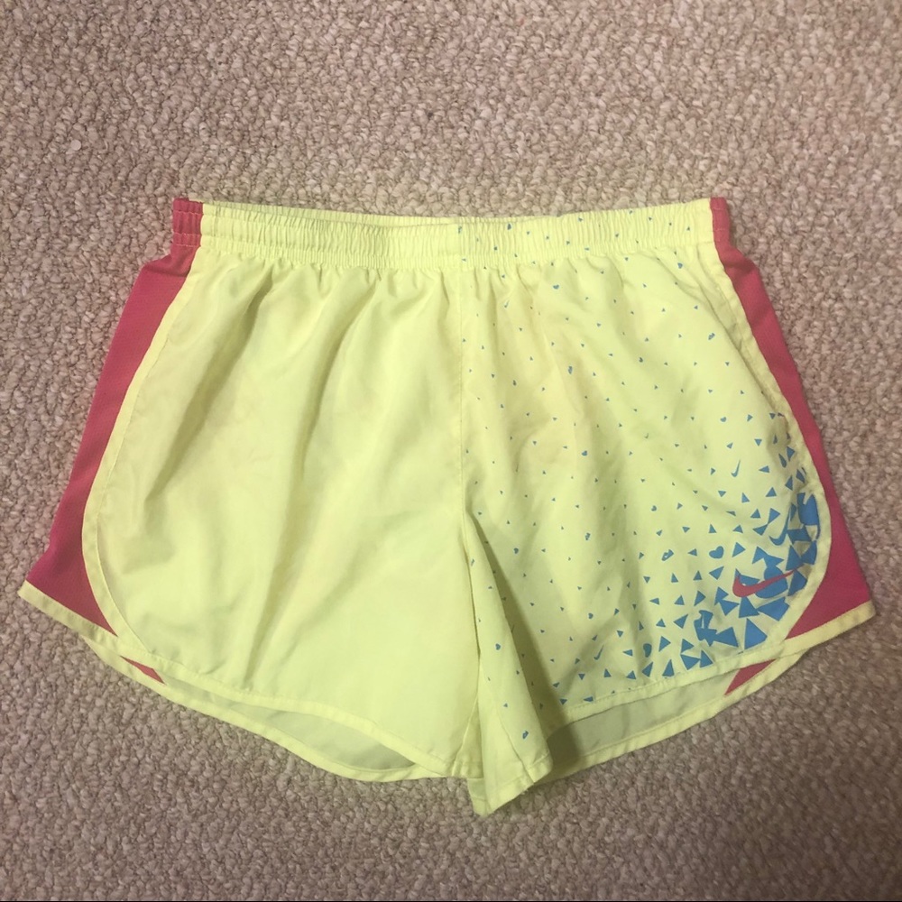Neon yellow and pink girl’s Nike running shorts